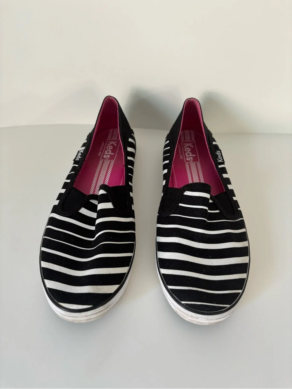 Keds Women’s Black & White Striped Slip-On Sneakers with Pink Insole